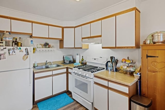 kitchen featuring white appliances, white cabinets, sink, and light wood-type flooring