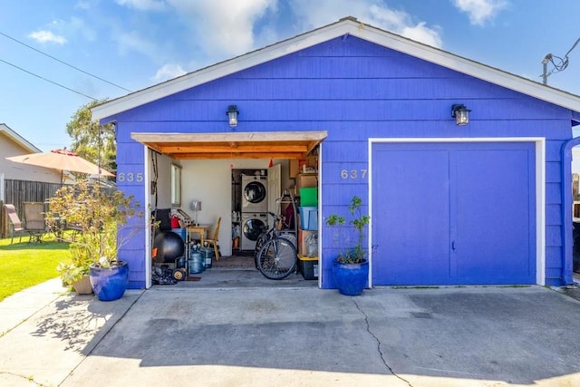 garage with stacked washer and dryer