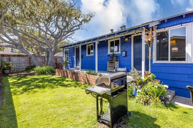 rear view of house with a yard