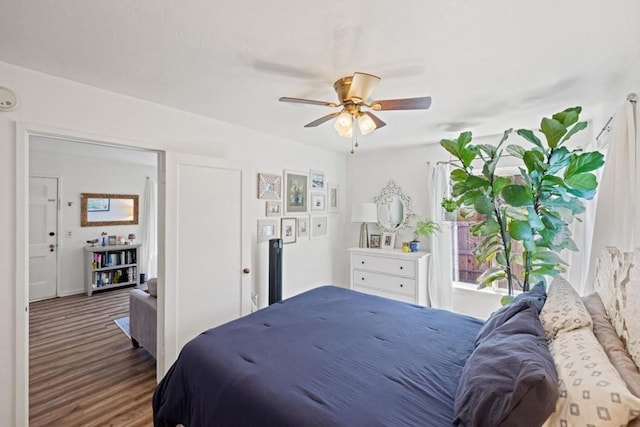 bedroom with dark wood-type flooring and ceiling fan