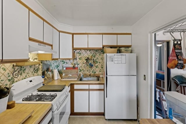 kitchen with white cabinets, backsplash, white appliances, and sink