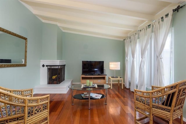 living room with a brick fireplace, beamed ceiling, and dark hardwood / wood-style floors