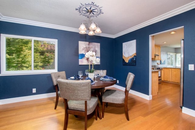 dining area featuring a notable chandelier, light wood-type flooring, and a wealth of natural light