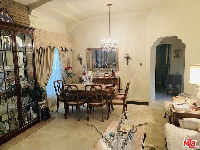 dining room with an inviting chandelier and vaulted ceiling