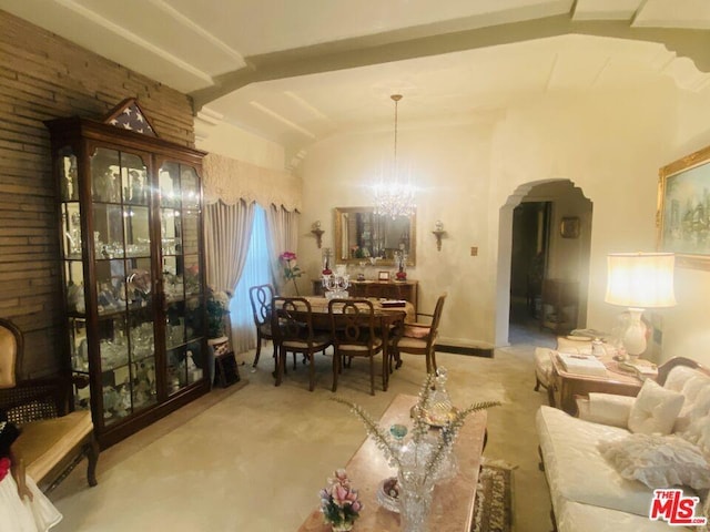 carpeted living room with lofted ceiling and a notable chandelier