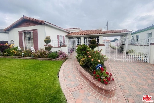 mediterranean / spanish home featuring a front yard