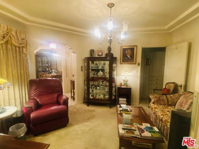 living room with an inviting chandelier, light carpet, and ornamental molding