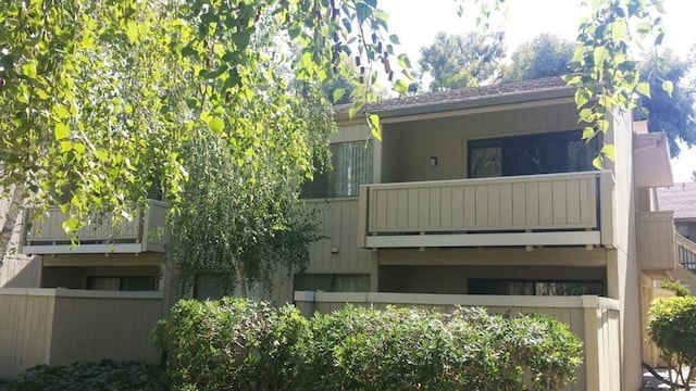 back of house featuring a balcony