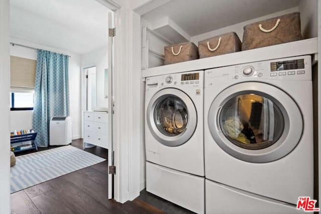 clothes washing area featuring washer and dryer and dark hardwood / wood-style flooring