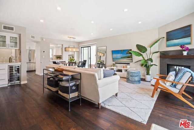 living room with beverage cooler and wood-type flooring