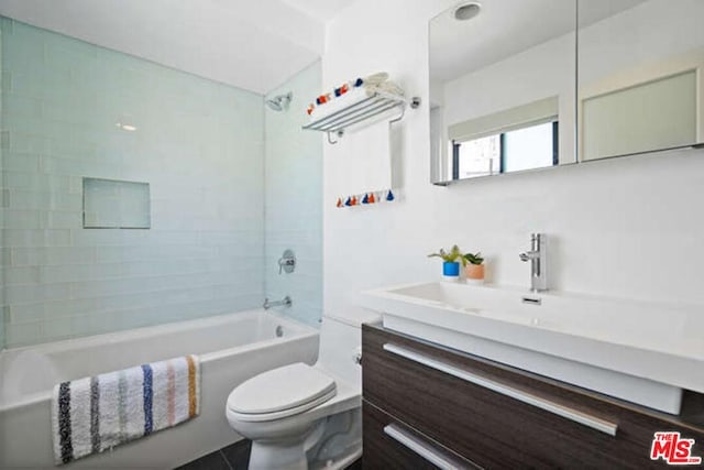 full bathroom with tiled shower / bath, toilet, and large vanity