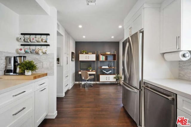 kitchen featuring white cabinetry, dark hardwood / wood-style flooring, and stainless steel appliances