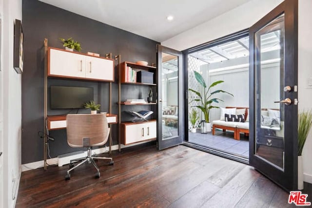 home office with dark wood-type flooring and french doors