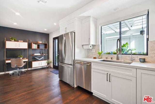 kitchen featuring white cabinetry, dark wood-type flooring, sink, and stainless steel appliances