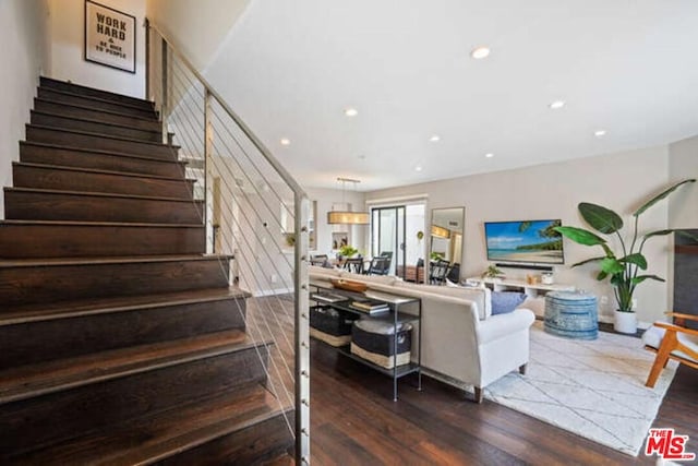 staircase with dark wood-type flooring