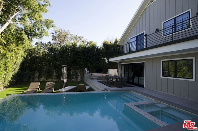 view of pool featuring a patio and an in ground hot tub