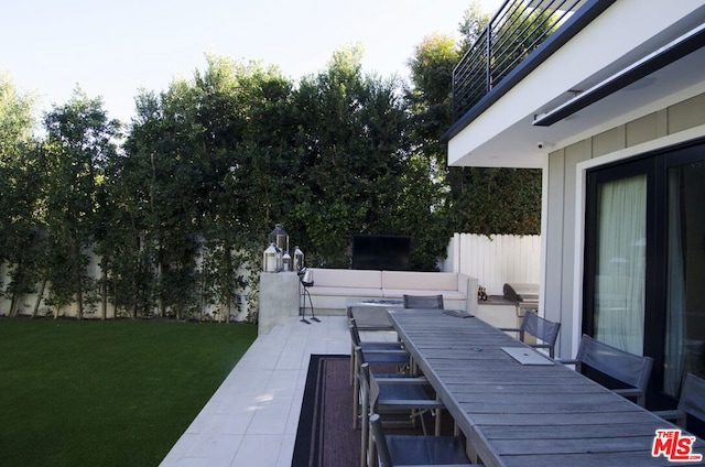 wooden deck featuring a yard and a patio