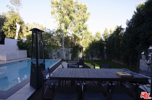 view of patio / terrace with a fenced in pool