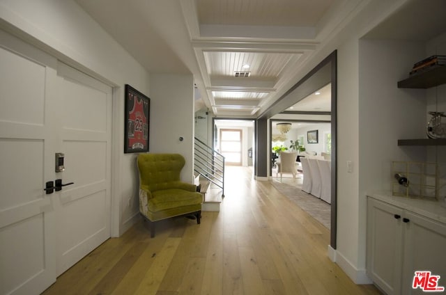 hall featuring light hardwood / wood-style floors and beam ceiling