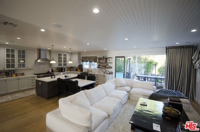 living room with wooden ceiling, sink, and hardwood / wood-style flooring