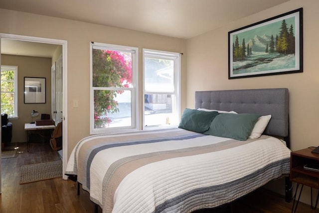 bedroom with dark hardwood / wood-style floors