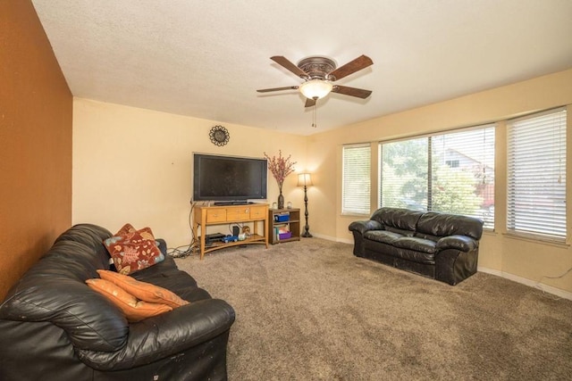 carpeted living room with ceiling fan