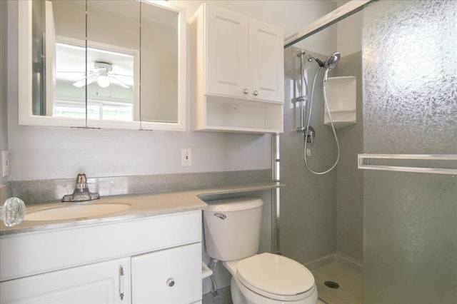 bathroom with walk in shower, vanity, toilet, and ceiling fan