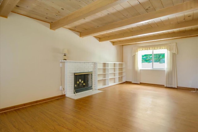 unfurnished living room featuring wooden ceiling, hardwood / wood-style flooring, beamed ceiling, and a brick fireplace