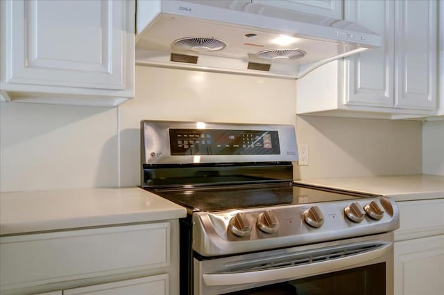 kitchen with range hood, white cabinets, and stainless steel electric range