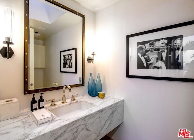 bathroom featuring vanity with extensive cabinet space