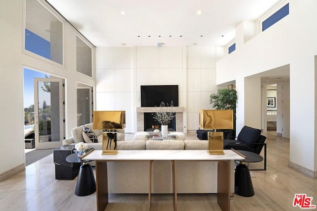 tiled living room with a high ceiling