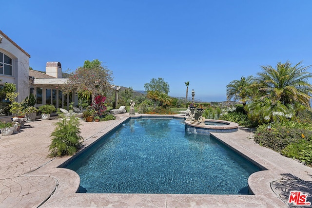 view of pool with a patio and an in ground hot tub