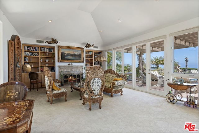 carpeted living room with vaulted ceiling