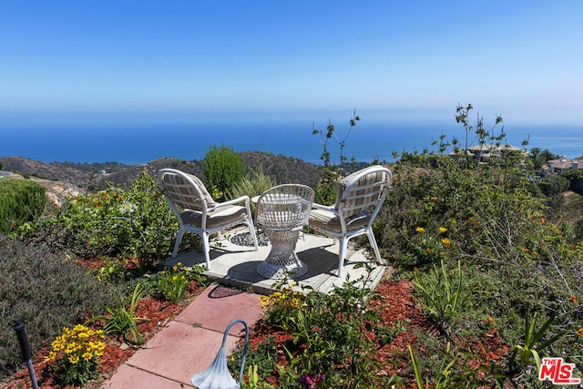 view of patio featuring a water view