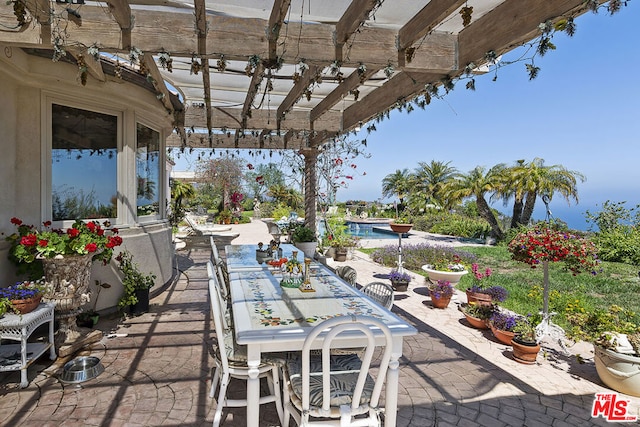 view of patio / terrace featuring a swimming pool and a pergola