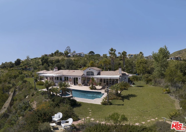 rear view of property with a patio area and a lawn