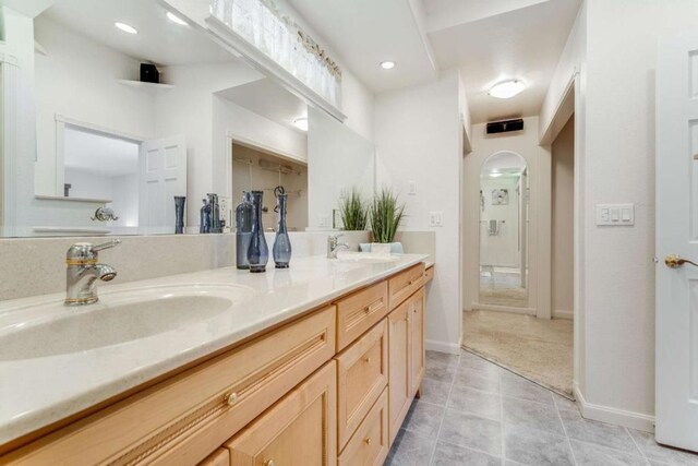 bathroom featuring double vanity and tile patterned flooring