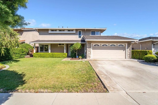 view of front of property featuring a front yard and a garage