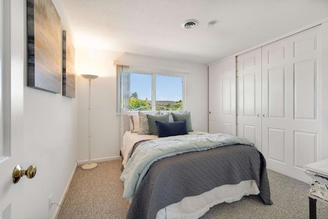 carpeted bedroom with a closet