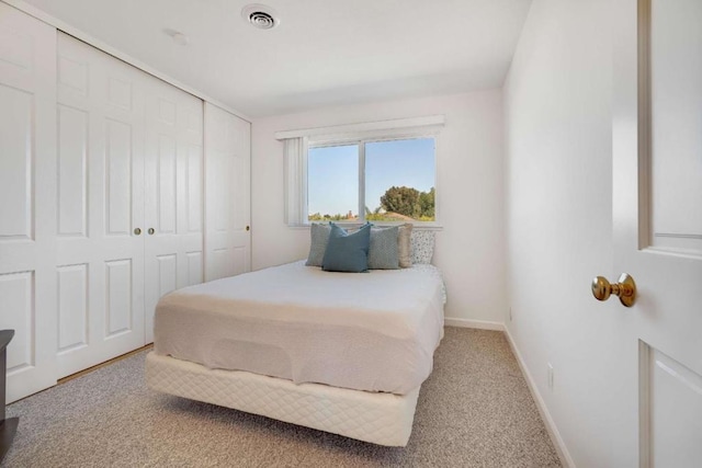 bedroom featuring a closet and light colored carpet