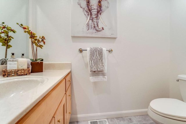 bathroom with vanity, toilet, and tile patterned flooring