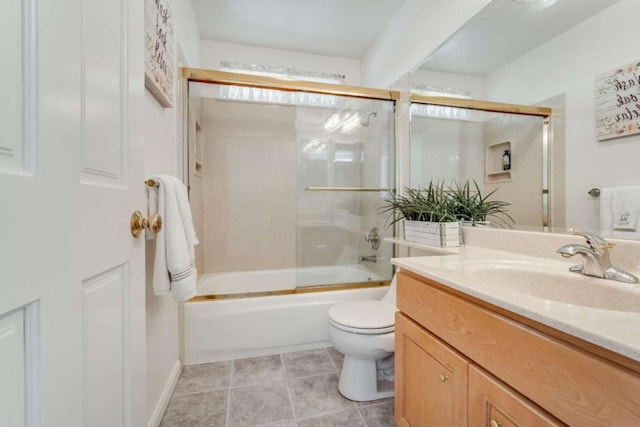 full bathroom with tile patterned floors, vanity, toilet, and shower / bath combination with glass door