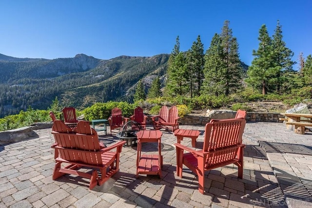 view of patio featuring a mountain view and a fire pit