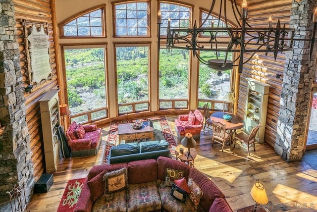 sunroom / solarium featuring an inviting chandelier