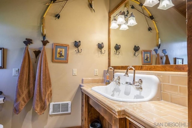 bathroom featuring vanity with extensive cabinet space