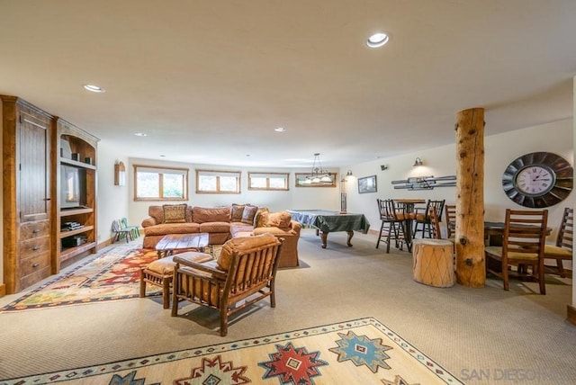 carpeted living room featuring an inviting chandelier and billiards