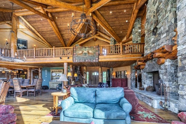 interior space featuring a notable chandelier, high vaulted ceiling, dark hardwood / wood-style floors, and a fireplace