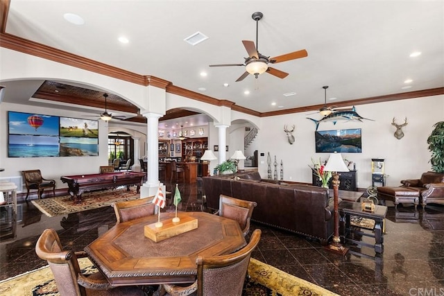 tiled dining space featuring crown molding, ceiling fan, and decorative columns