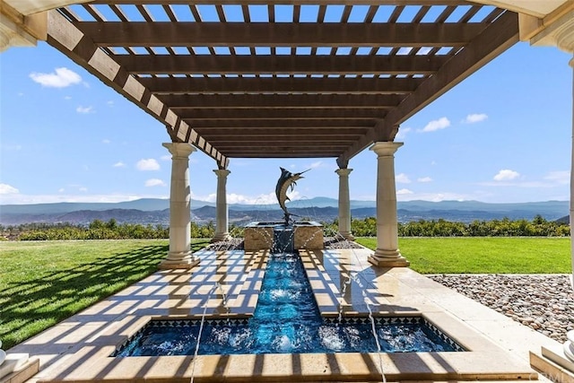 view of patio featuring a pergola, a mountain view, and an in ground hot tub