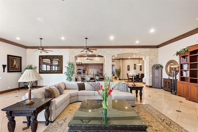 tiled living room featuring ornamental molding and ceiling fan